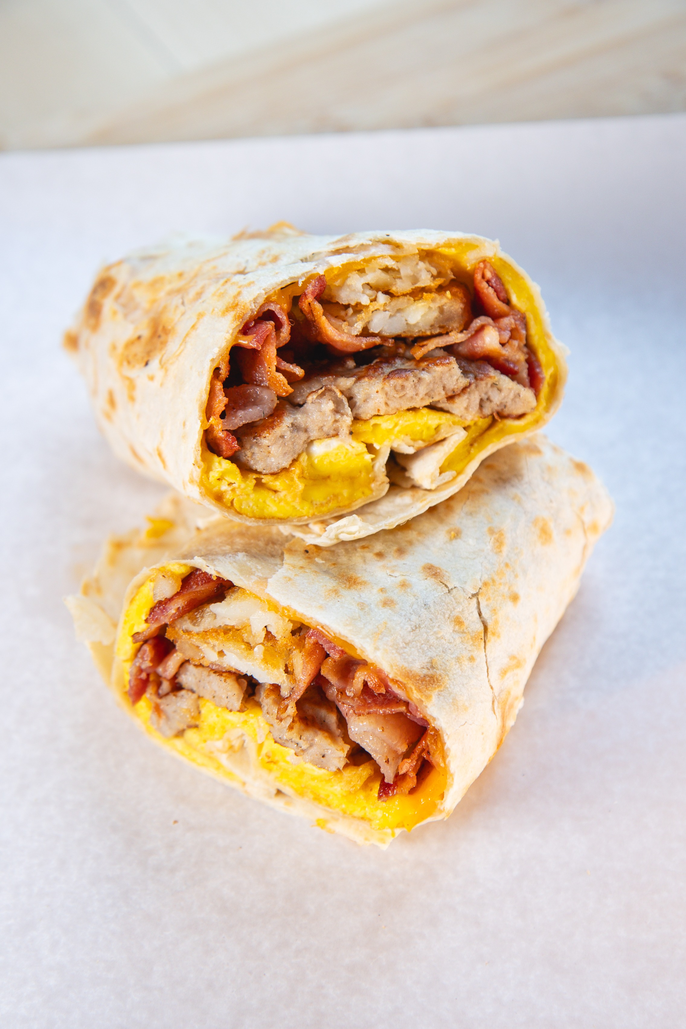 Breakfast wrap with bacon, eggs, sausage, and cheese